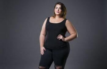 Obese young woman wearing black sporty clothes.